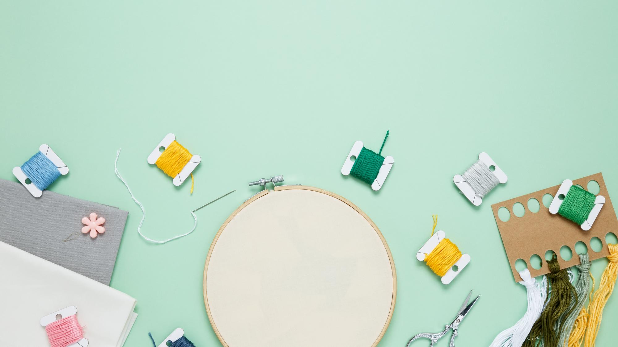 workshop table with threads and embroidery sample
